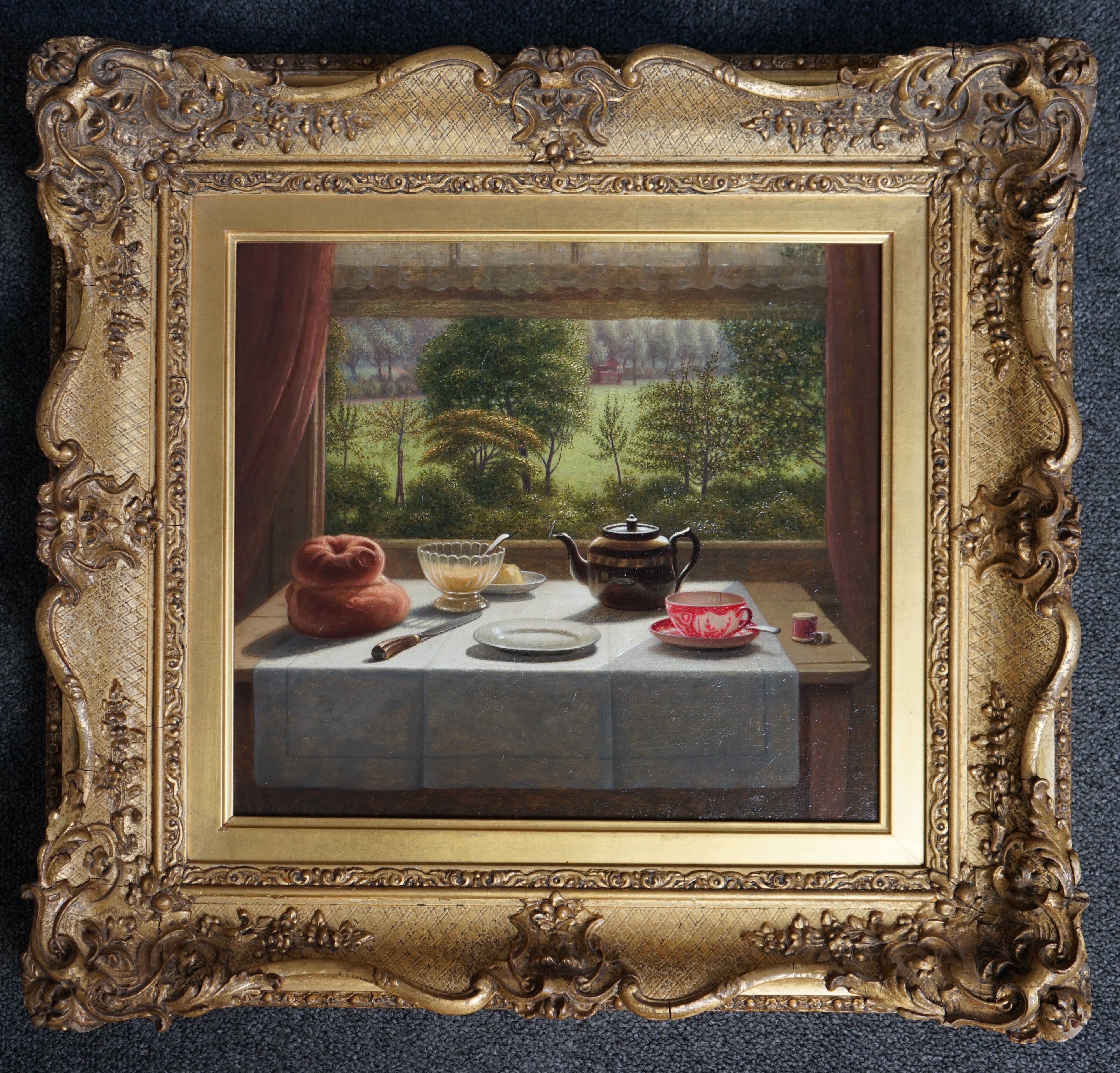 Arthur George Ventnor (British, 1866-1934), Tea table still life with parkland beyond, oil on canvas, 27 x 30cm